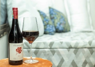 wine glass on top of cultural side table for a guest to sip while on stay in Ukarimu Hosts, Arusha